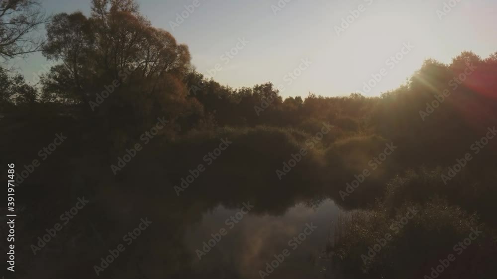 Aerial video flying over trees and field during sunset in autumn time Aerial video flying over trees and field during sunset in autumn time