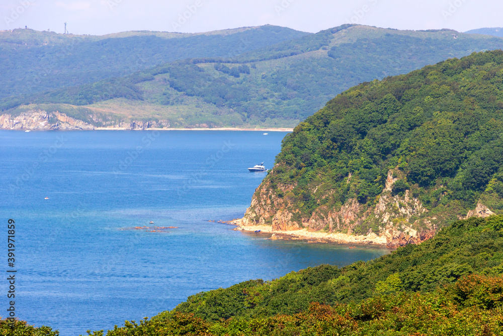 Picturesque landscape overlooking the rocks and the sea on a sunny summer day on the Shkota island in Vladivostok.