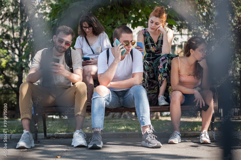 Using Internet With Friends Photo Group of friends using smartphones together. Young people addiction to ...