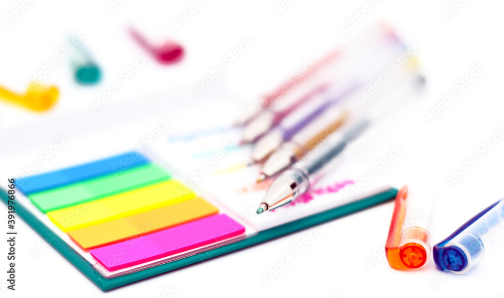 Various colored pencils, paper, notes on white background. Various colored pencils, paper, notes on white background.