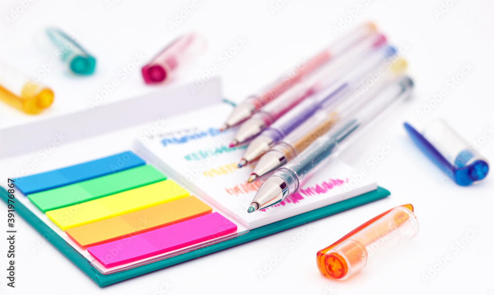 Various colored pencils, paper, notes on white background. Various colored pencils, paper, notes on white background.