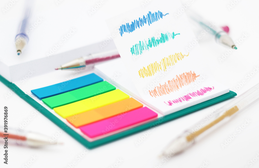 Various colored pencils, paper, notes on white background. Various colored pencils, paper, notes on white background.