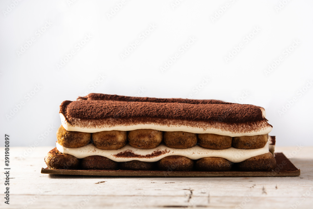 Traditional tiramisu cake isolated on white background Traditional tiramisu cake isolated on white background