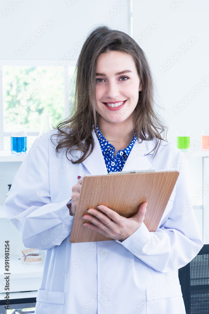 A female scientist holding a clipboard in the lab. A female scientist holding a clipboard in the lab.