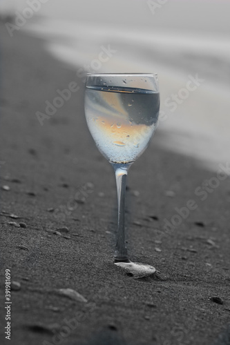 orange color drink in a glass on the beach