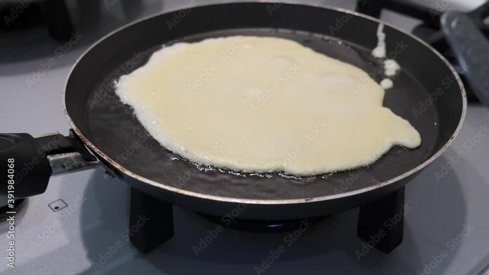 preparation of thin ruddy pancakes. baking in a pan preparation of thin ruddy pancakes. baking in a pan