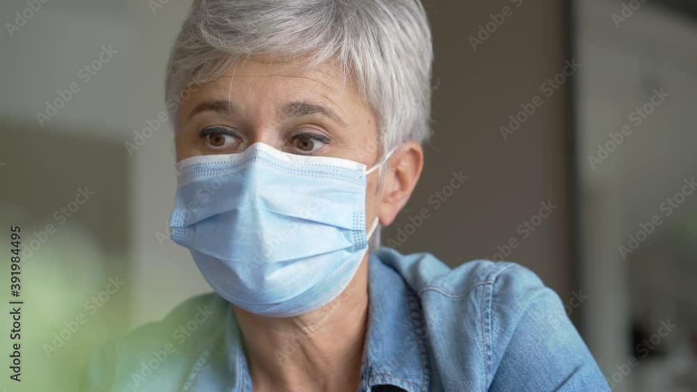 55 year old senior woman with white hair working out with mask
