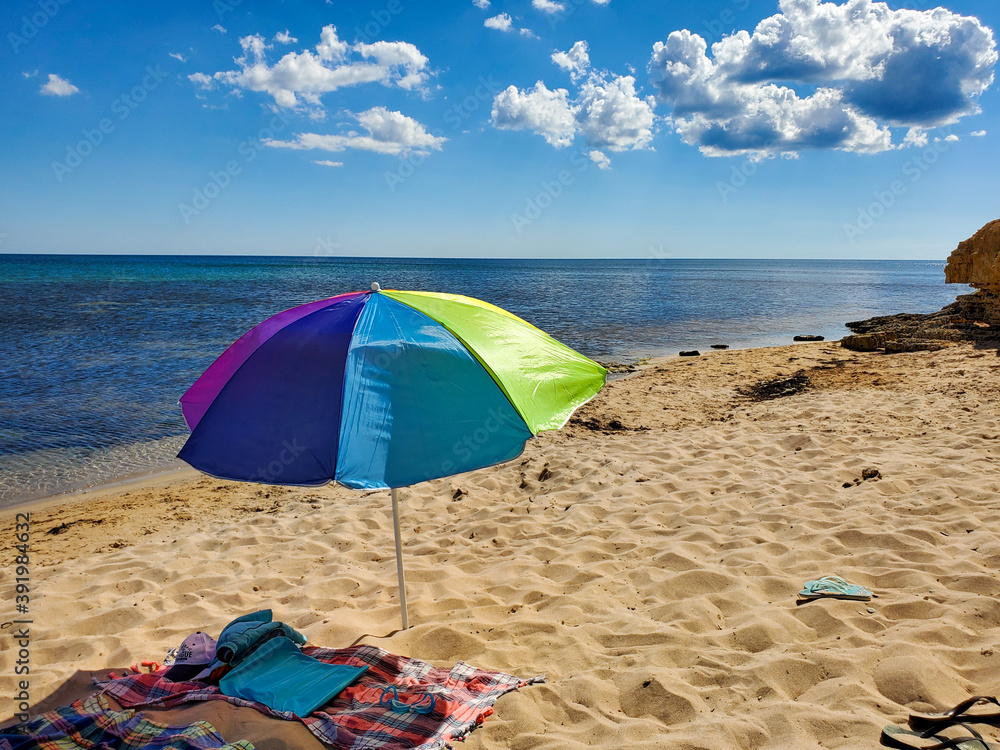 sun umbrella on a sandy beach with turquoise sea and blue sky on a Sunny summer day. sun umbrella on a sandy beach with turquoise sea and blue sky on a Sunny summer day.