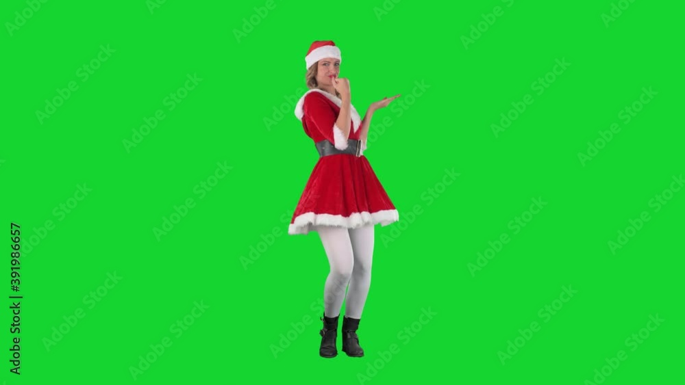 Excited cheerful Santa girl presenting and advertising amazed and joyful. Full body on chroma key green screen. Excited cheerful Santa girl presenting and advertising amazed and joyful. Full body on chroma key green screen.