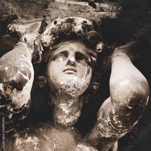 Bild auf Leinwand Ancient statue of Sisyphus rolling very big stone to top of high mountain rock in the kingdom of Hades, which beforу reach the top of mountain rolled back down every time