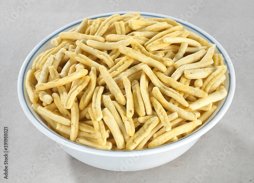 Bhavnagari Gathiya or gathia, ganthia, ganthiya, papdi, Champakali made by gram flour, Indian Pouch Packing Street Food, Namkeen or namkin, selective focus - Image