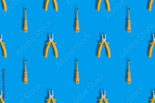 Tools seamless pattern. Screwdriver and pliers with rubber pads. Tools background.