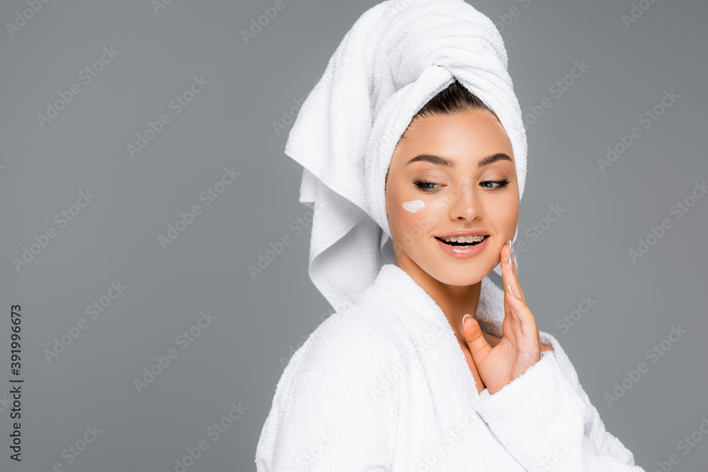 smiling woman with towel on head and cosmetic cream on face isolated on grey smiling woman with towel on head and cosmetic cream on face isolated on grey