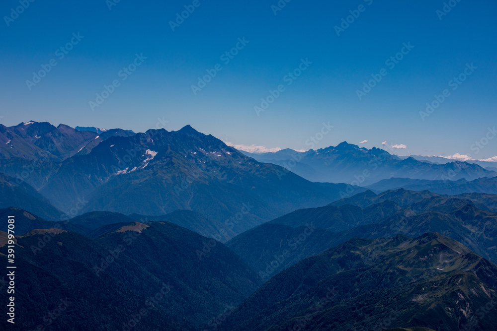 View of endless mountain ranges in the haze of the day View of endless mountain ranges in the haze of the day