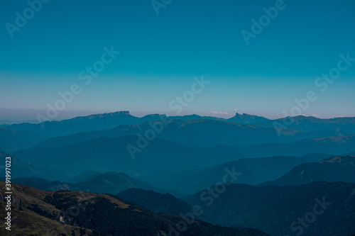 View of endless mountain ranges in the haze of the day