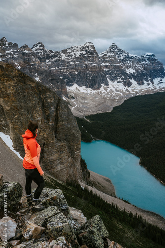 Hiker/active woman looking to the Moraine Lake from the top of Tower of Babel, Banff National Park, Alberta, Canada