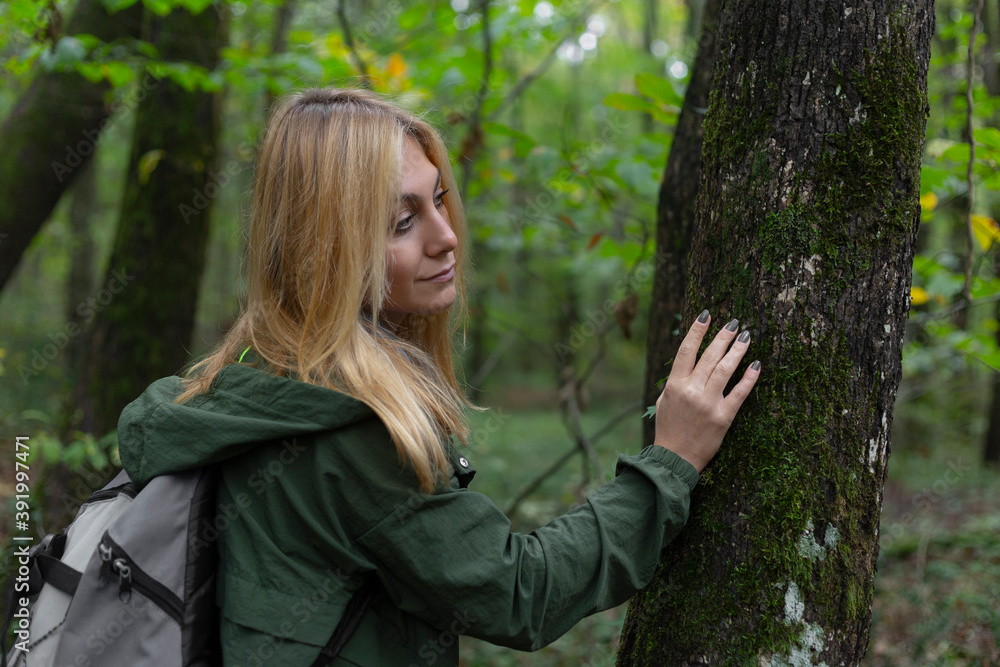 Beautiful woman alone in the forest in autumn