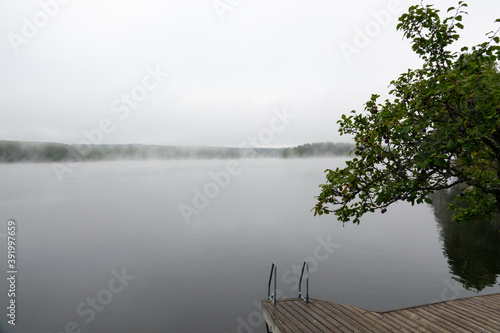 Misty morning at a lake during sunrise photo