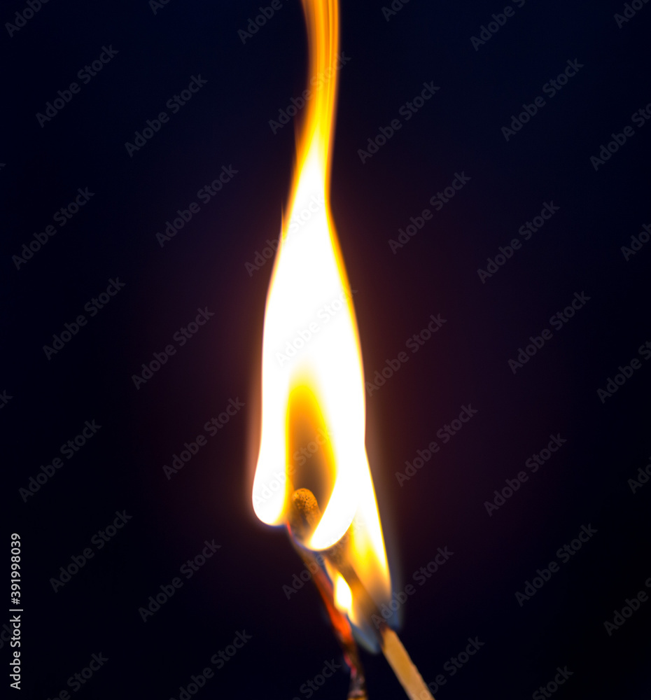 two matchstick lit on black background
