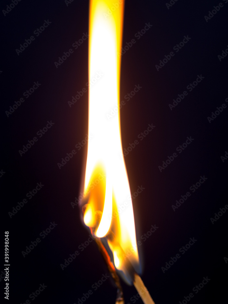two matchstick lit on black background two matchstick lit on black background