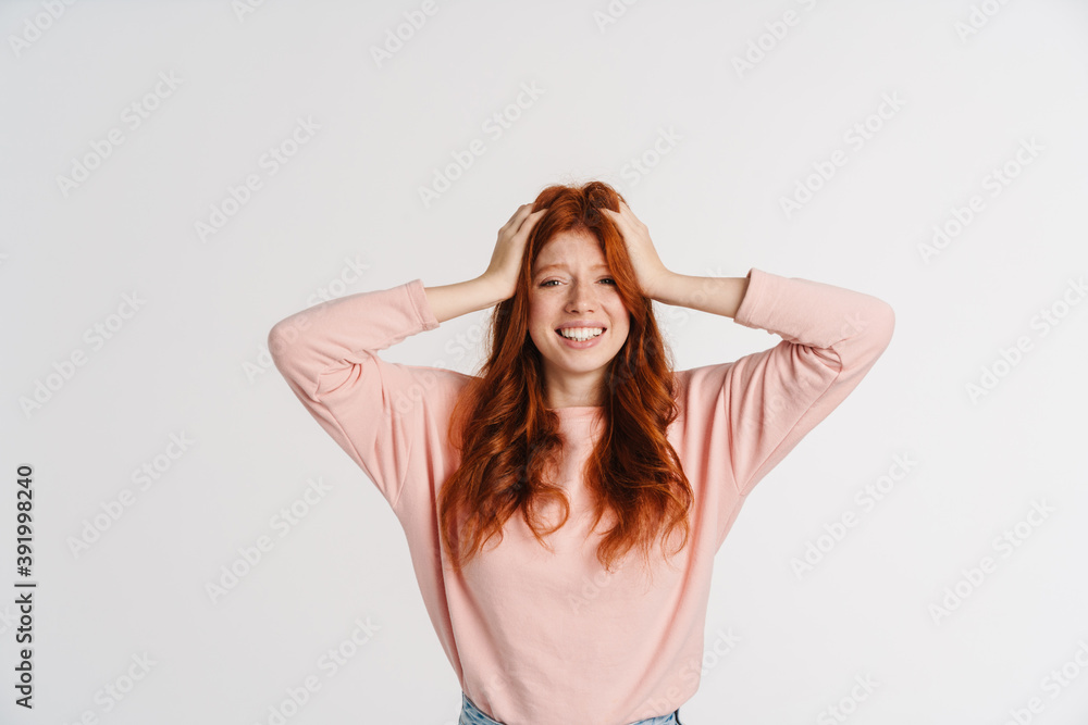 Ginger beautiful happy girl grabbing her head and smiling Ginger beautiful happy girl grabbing her head and smiling