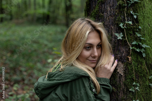 Beautiful woman alone in the forest in autumn