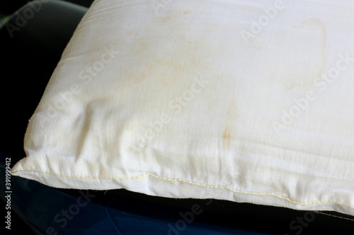 White old pillow with dirty stain. Selective focus