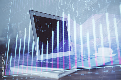 Forex market chart hologram and personal computer background. Double exposure. Concept of investment. © peshkova