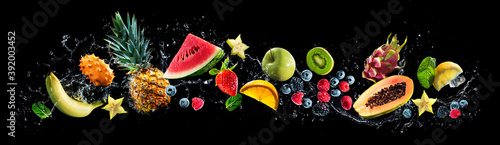 Valokuva Assortment of fresh fruits and water splashes on panoramic background
