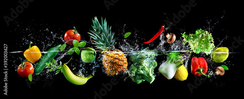 Fresh vegetables, fruits and water splashes on panoramic background
