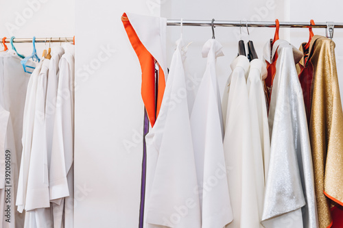 liturgical vestments of a priest hanging on hangers in the church sacristy photo