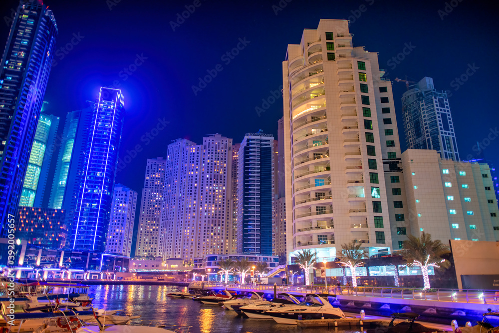 DUBAI, UAE - DECEMBER 6, 2016: Dubai Marina at night. city promenade. Skyscrapers along the canals
