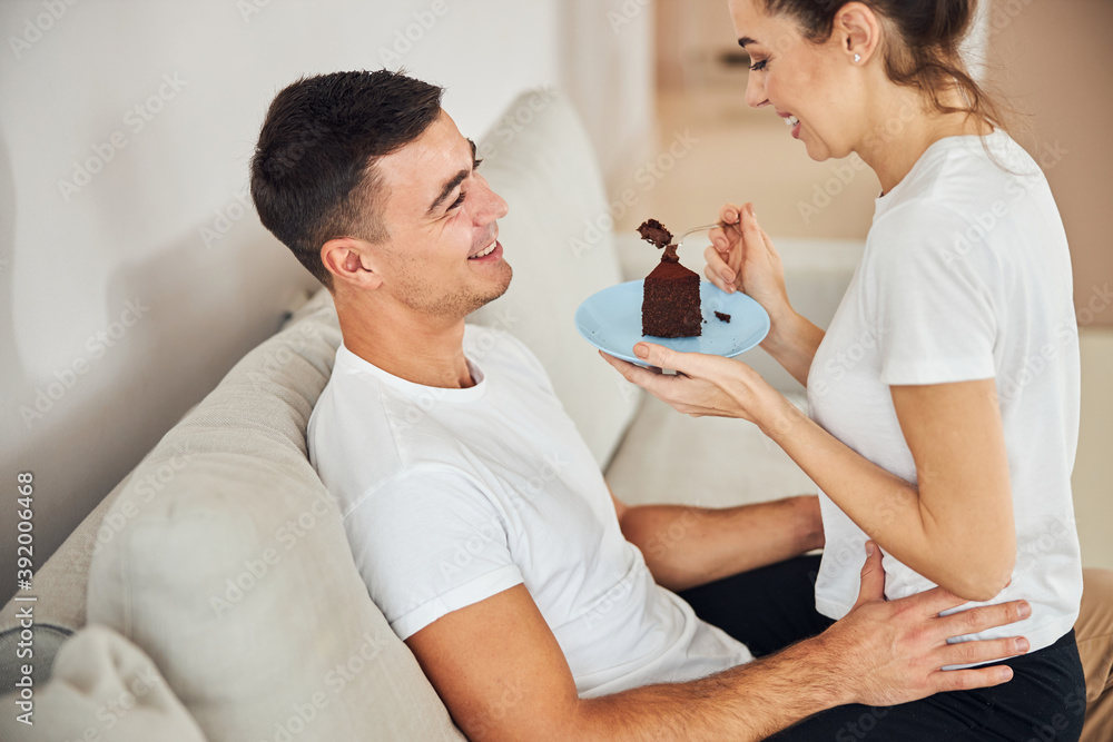 Joyous young man holding his girlfriend on his lap Joyous young man holding his girlfriend on his lap