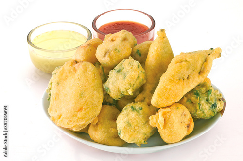 Indian Street Fried Food Pakora Also Know as Pakoda, Bhajiya, Bhajia, Methi Gota, Kanda Bhaji, Pyaz Pakoda, Fried Chillies, Onion Wada, potato vada, aloo Bhajji or fritter, Served with Chutney.