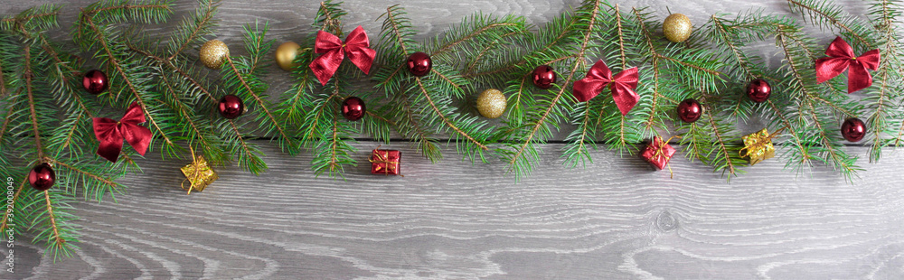 Wide Christmas border on wood, composed of green branches, red balls and ribbons, small giftboxes. Wide Christmas border on wood, composed of green branches, red balls and ribbons, small giftboxes.
