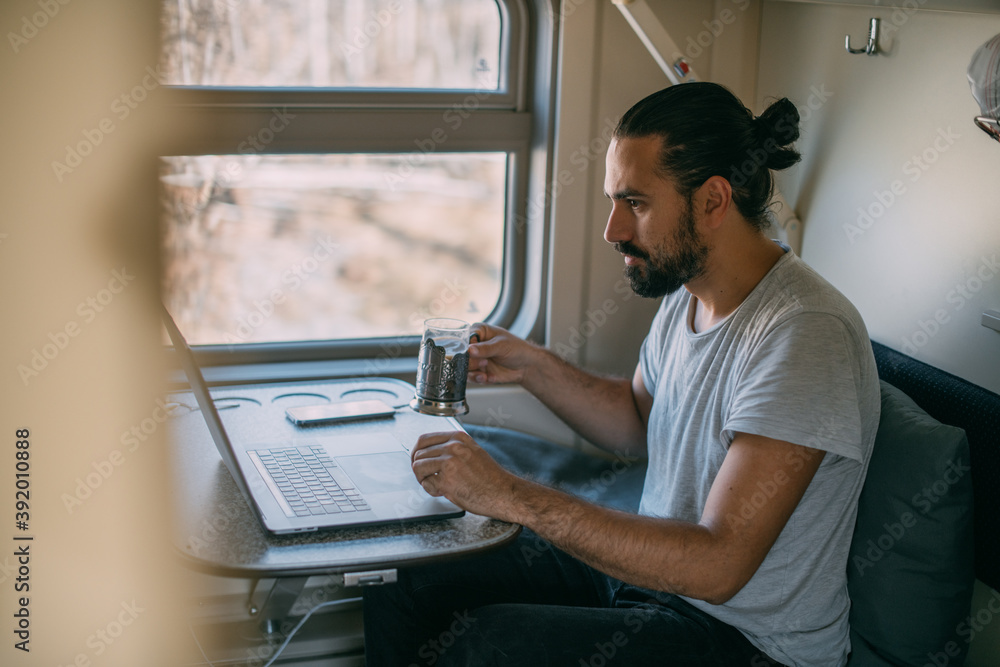 Man with laptop on the train. Man with laptop on the train.