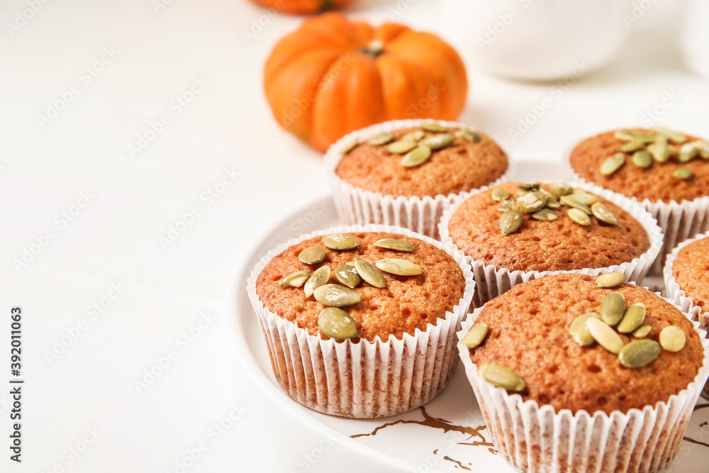Plate with tasty pumpkin muffins on table, closeup Plate with tasty pumpkin muffins on table, closeup