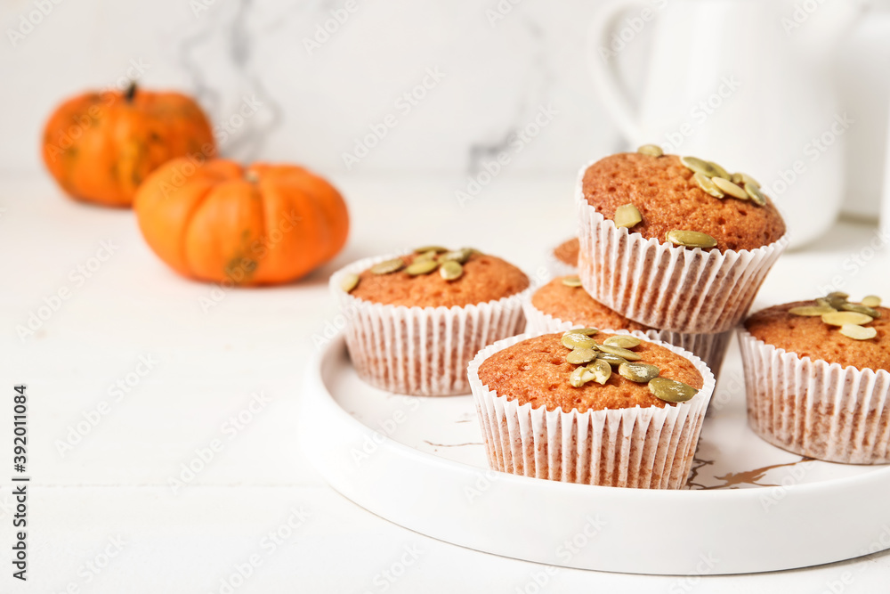 Plate with tasty pumpkin muffins on table Plate with tasty pumpkin muffins on table
