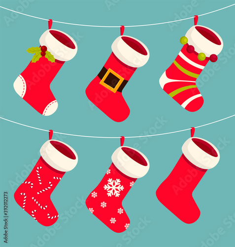 Cute Xmas red and white socks or stocking hanging on a rope. Christmas and New year holiday. Traditional decorations for gifts with pattern. Vector cartoon Illustration.