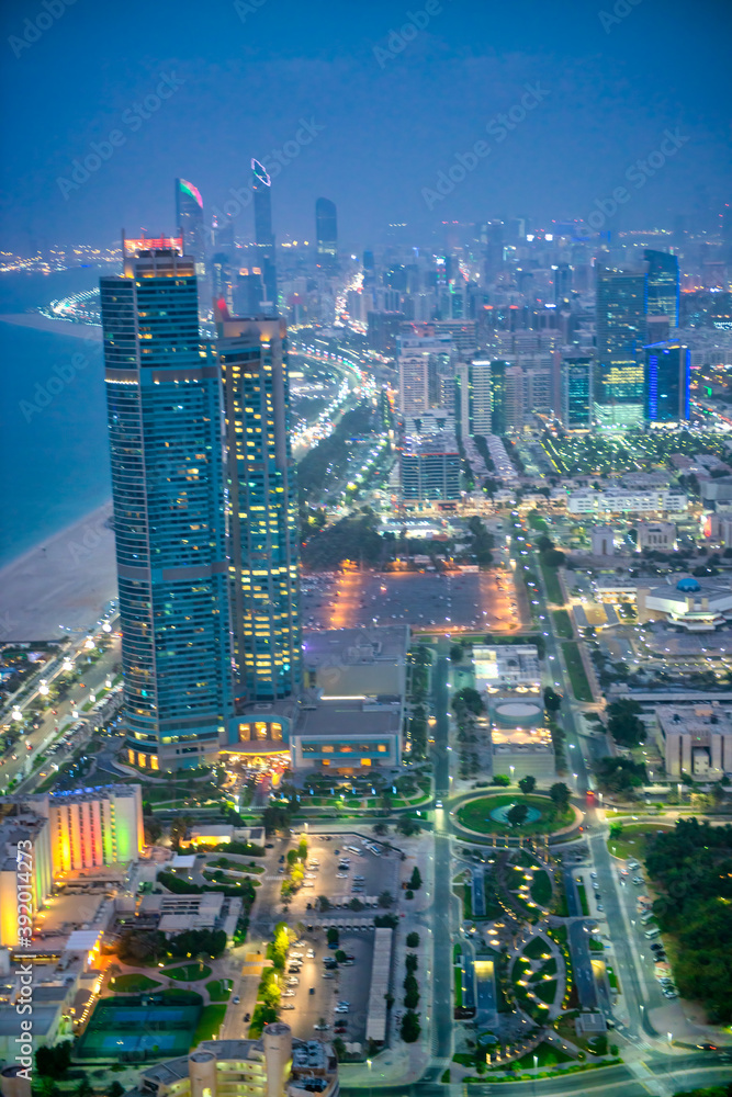 Fototapeta premium Abu Dhabi skyline along Corniche Road at night, UAE