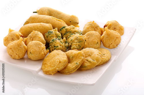 Indian Street Fried Food Pakora Also Know as Pakoda, Bhajiya, Bhajia, Methi Gota, Kanda Bhaji, Pyaz Pakoda, Fried Chillies, Onion Wada, potato vada, aloo Bhaji or fritter, Served with Chutney.