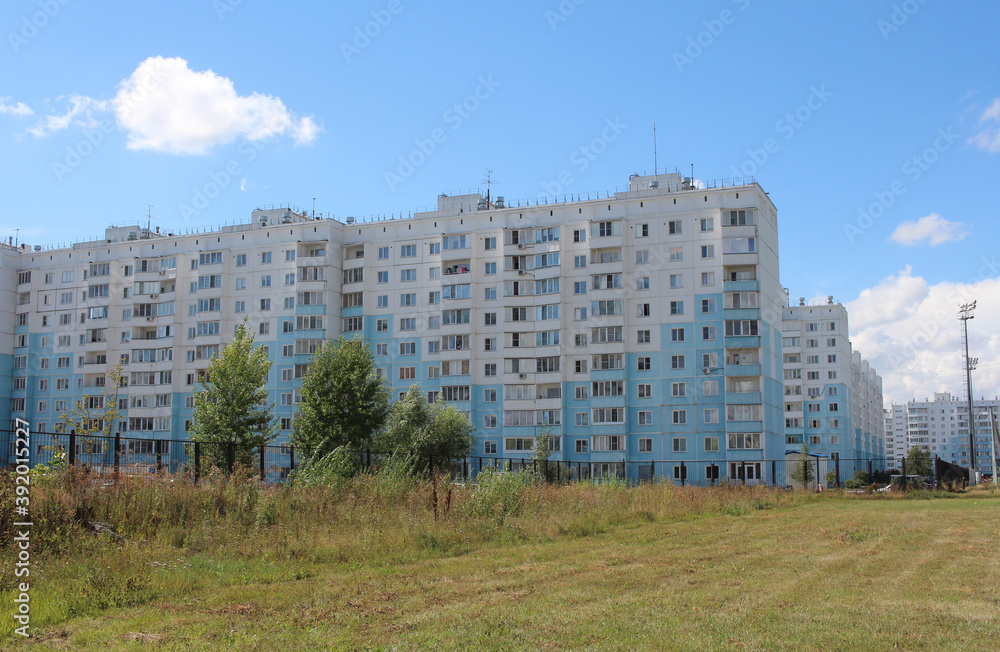 Multi-apartment buildings modern architecture in the city area with a lawn in the yard