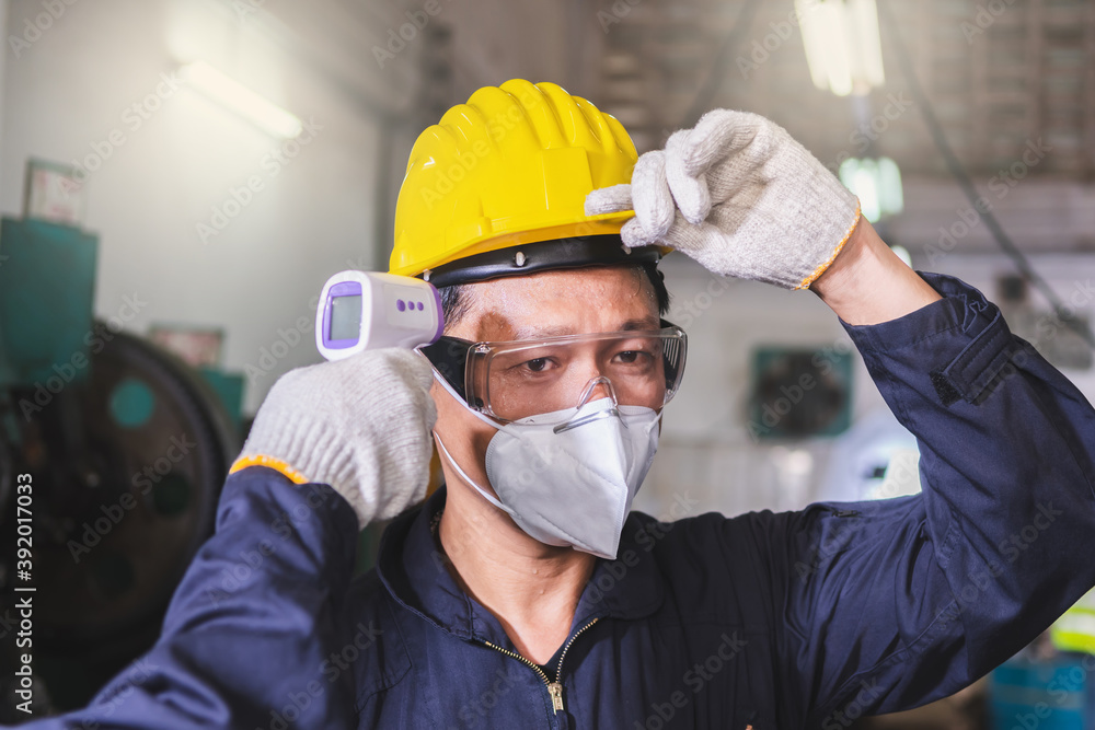 Checking temperature the worker inside the factory Checking temperature the worker inside the factory