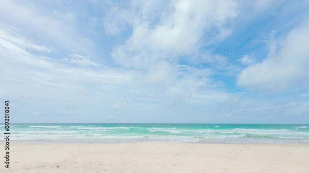4k Timelapse of bright blue sky in sunny day. Landscape of Clear ocean and waves with white fine sandy beach lined in horizontal in tropical country. Sunlight shine reflected on coconut leaves. 4k Timelapse of bright blue sky in sunny day. Landscape of Clear ocean and waves with white fine sandy beach lined in horizontal in tropical country. Sunlight shine reflected on coconut leaves.