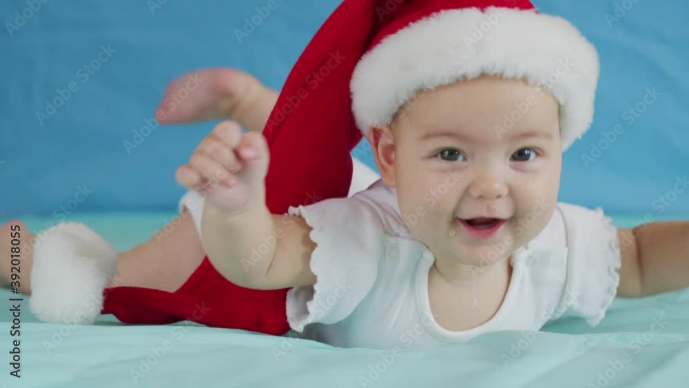 Portrait of adorable infant baby girl wearing Santa hat. Christmas celebration concept. Portrait of adorable infant baby girl wearing Santa hat. Christmas celebration concept.