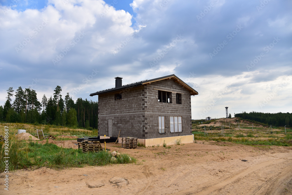 Building a house of expanded-clay concrete blocks. Unfinished private home of ceramsite concrete blocks on a construction site.Technology of construction work and laying bricks