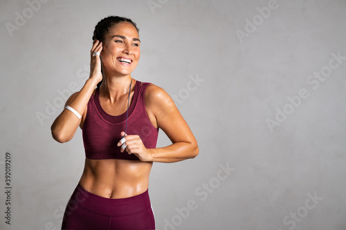 Fitness mid woman laughing after gym workout
