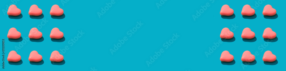 Composition background of pink heart candy on the blue background. Valentines Day concept banner Composition background of pink heart candy on the blue background. Valentines Day concept banner