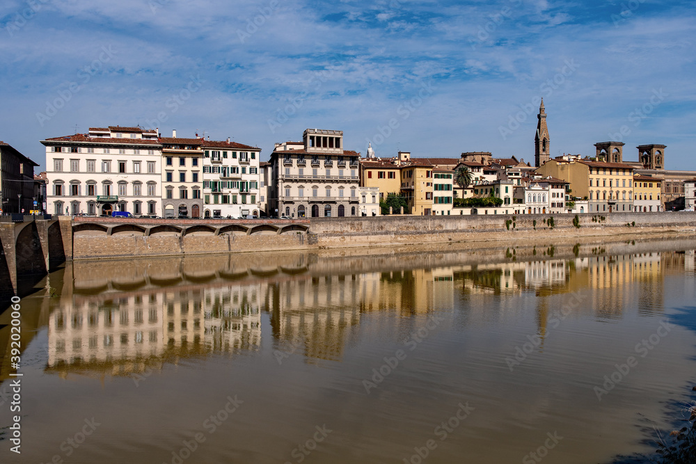 Row of houses reflecting in the Arno River at the old town of Florence, Tuscany Region in Italy 