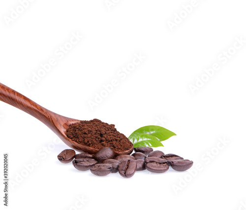 Coffee beans with ground coffee in a spoon on a white background